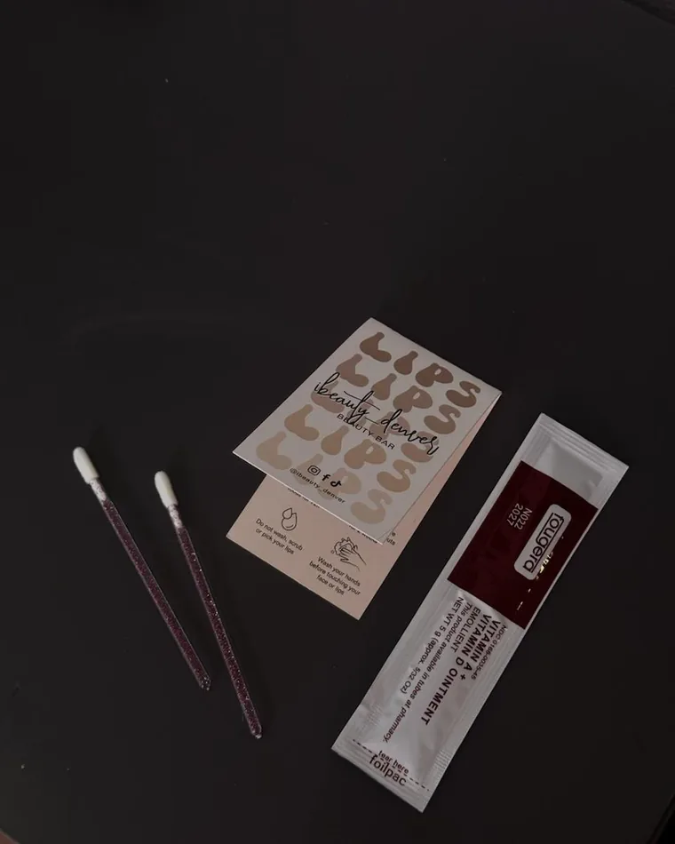 Sealed single-use needles and tools laid out in the studio